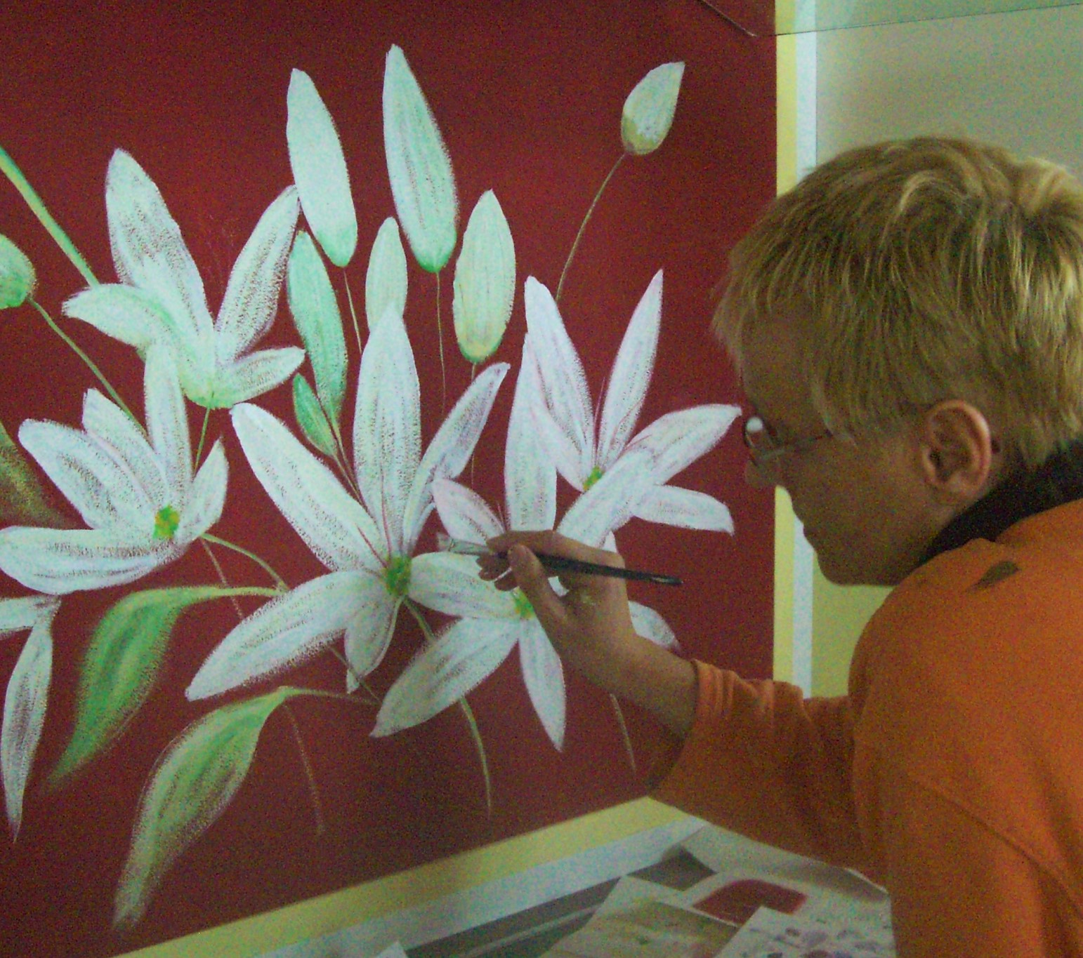 an der Wand über dem Herz wird gerade auf rotem Hintergrund ein blühender Bärlauch gemalt.